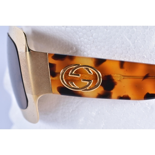 62 - A CASED PAIR OF GUCCI SUNGLASSES. 15 cm wide.