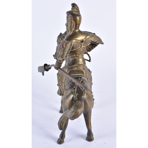 69 - A CHINESE QING DYNASTY BRONZE FIGURE OF A WARRIOR ON HORSEBACK inset with gems, embellished in motif... 