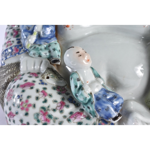 93 - AN EARLY 20TH CENTURY CHINESE FAMILLE ROSE PORCELAIN FIGURE OF A BUDDHA Late Qing/Republic, modelled... 