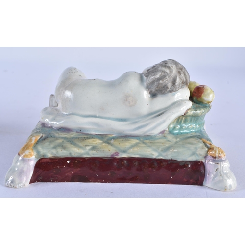 114 - AN EARLY 19TH CENTURY ENGLISH PEARLWARE FIGURE OF A RECLINING CHILD together with an early salt glaz... 