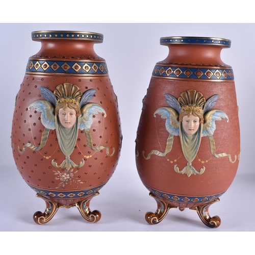 116 - A RARE PAIR OF 19TH CENTURY METTLACH POTTERY VASES decorated in relief with classical mask heads, un... 