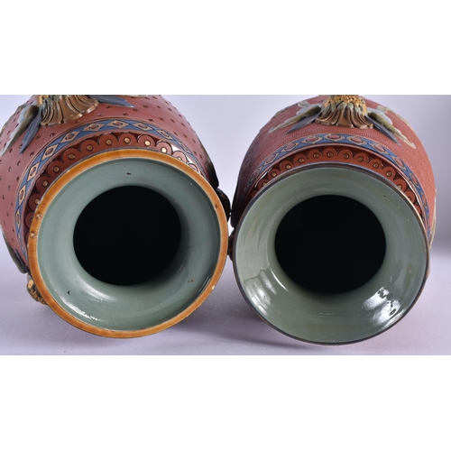 116 - A RARE PAIR OF 19TH CENTURY METTLACH POTTERY VASES decorated in relief with classical mask heads, un... 