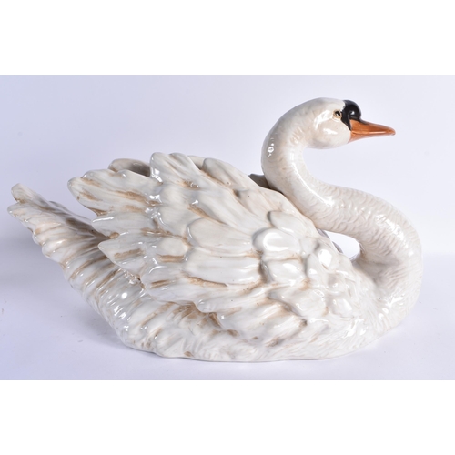 126 - A LARGE PAIR OF 19TH CENTURY CONTINENTAL COUNTRY HOUSE CERAMIC FIGURES OF SWANS modelled with natura... 