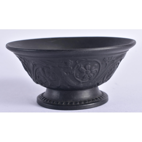 128 - A WEDGWOOD BLACK BASALT FLARED BOWL decorated with floral sprays. 8 cm diameter.