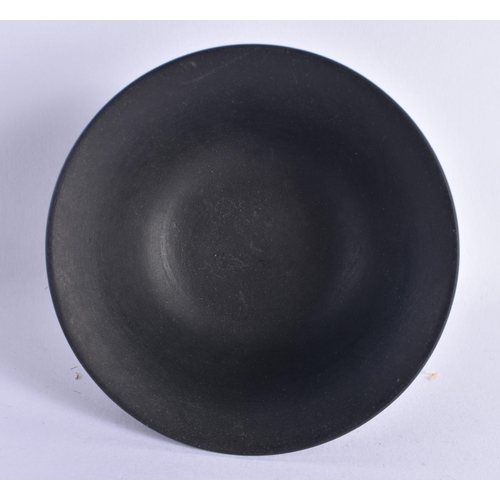 128 - A WEDGWOOD BLACK BASALT FLARED BOWL decorated with floral sprays. 8 cm diameter.