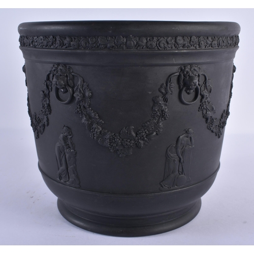 131 - A LARGE WEDGWOOD BLACK BASALT JARDINIERE decorated with figures, lion mask heads and trailing vines.... 