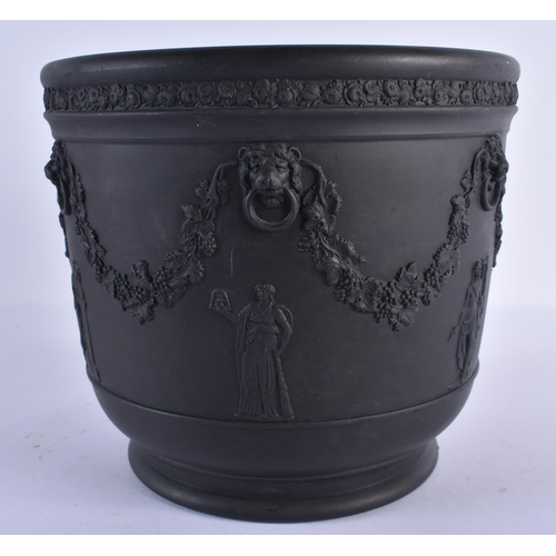 131 - A LARGE WEDGWOOD BLACK BASALT JARDINIERE decorated with figures, lion mask heads and trailing vines.... 