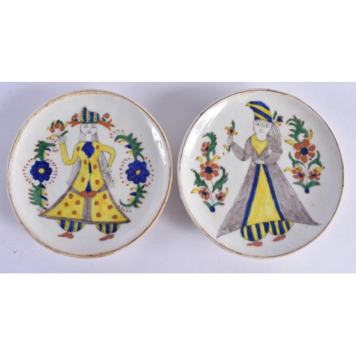 137 - A PAIR OF TURKISH KUTAHYA FAIENCE DISHES painted with figures. 14 cm diameter.