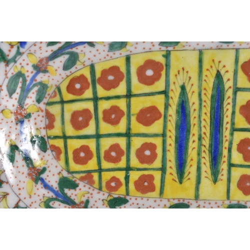 138 - A LARGE TURKISH KUTAHYA FAIENCE BARBERS DISH painted with motifs and flowers. 35 cm x 27 cm.