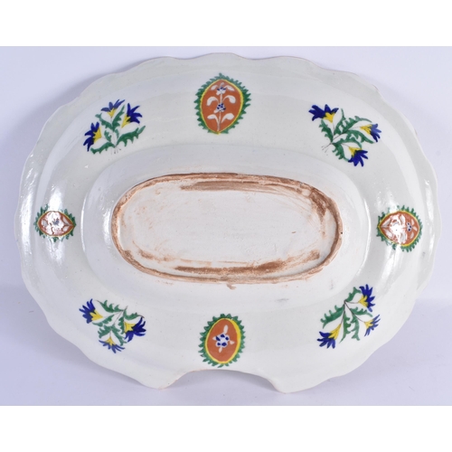 138 - A LARGE TURKISH KUTAHYA FAIENCE BARBERS DISH painted with motifs and flowers. 35 cm x 27 cm.