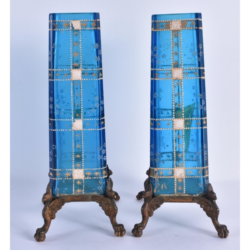 149 - A PAIR OF FRENCH AESTHETIC MOVEMENT BLUE GLASS AND BRONZE VASES enamelled with motifs. 18.5 cm high.