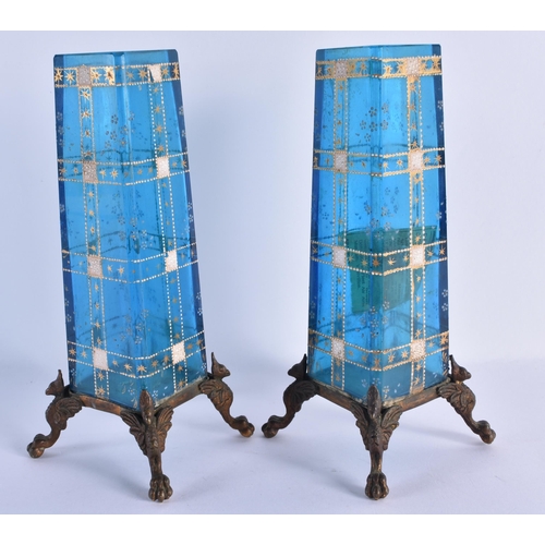 149 - A PAIR OF FRENCH AESTHETIC MOVEMENT BLUE GLASS AND BRONZE VASES enamelled with motifs. 18.5 cm high.