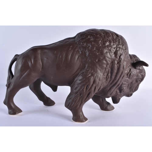 151 - A RETRO BROWN PAINTED GERMAN CERAMIC FIGURE OF A BISON. 35 cm x 22cm.