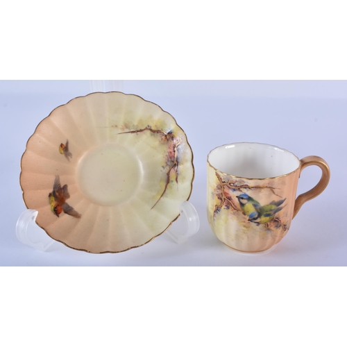 194 - Royal Worcester miniature coffee cup and saucer painted with flowers on a blush ivory ground, date 1... 