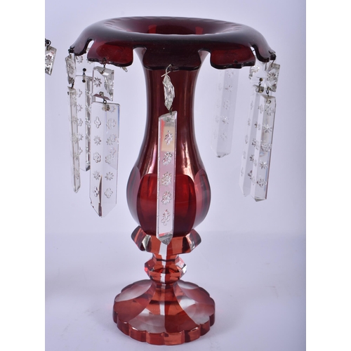 216 - A PAIR OF ANTIQUE CRANBERRY GLASS LUSTRES. 30 cm high.