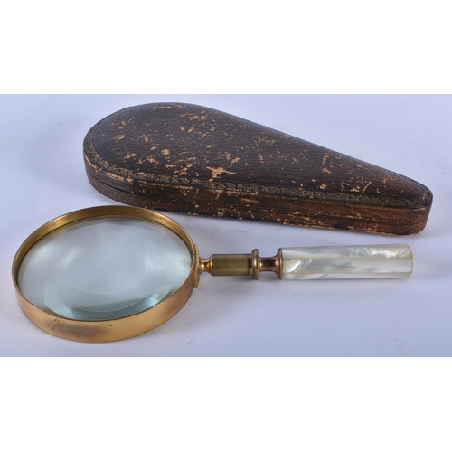 219 - A LARGE ANTIQUE LEATHER CASED MOTHER OF PEARL HANDLED MAGNIFYING GLASS. 24 cm long.