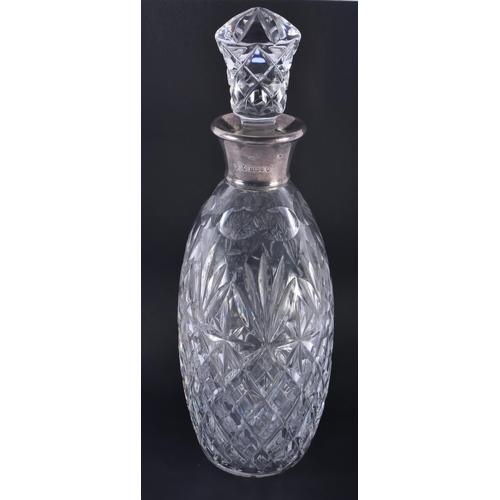 227 - AN ENGLISH SILVER MOUNTED CUT GLASS DECANTER AND STOPPER. 28 cm high.