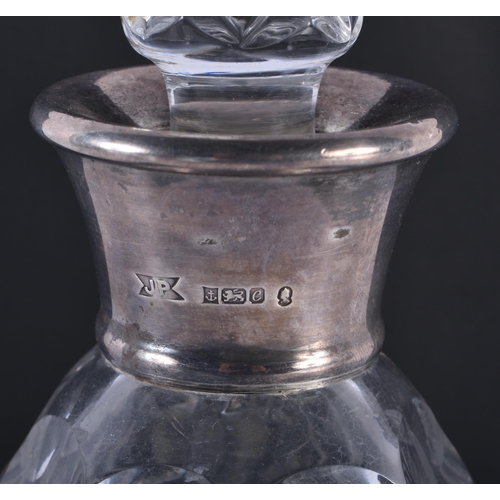 227 - AN ENGLISH SILVER MOUNTED CUT GLASS DECANTER AND STOPPER. 28 cm high.