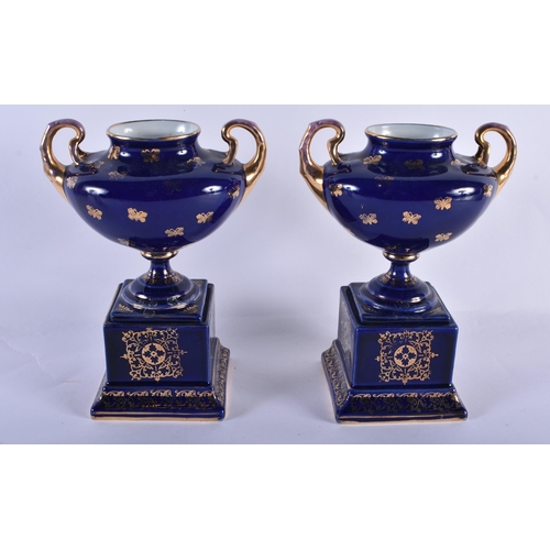 228 - A PAIR OF TWIN HANDLED VIENNA STYLE VASES. 18 cm x 14 cm.