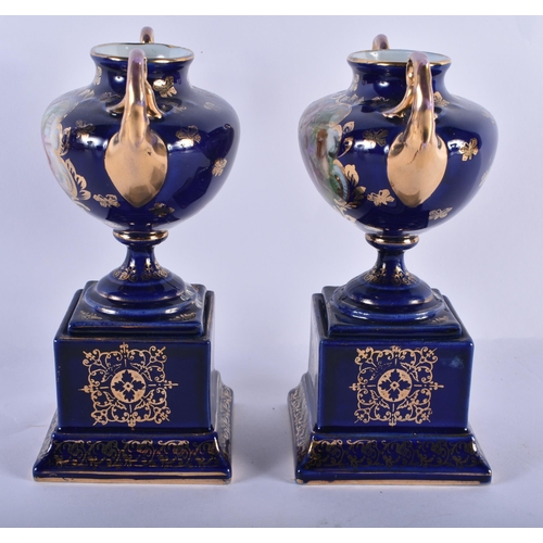 228 - A PAIR OF TWIN HANDLED VIENNA STYLE VASES. 18 cm x 14 cm.