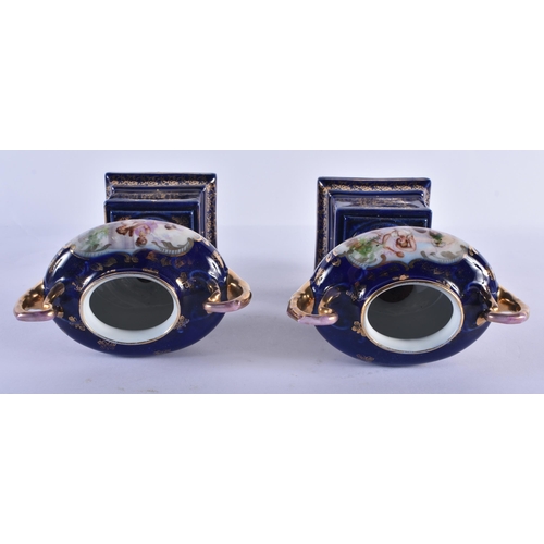 228 - A PAIR OF TWIN HANDLED VIENNA STYLE VASES. 18 cm x 14 cm.