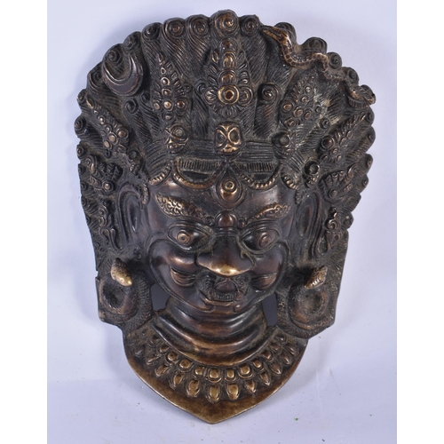 370 - A LARGE 19TH CENTURY TIBETAN BRONZE BUDDHISTIC MASK HEAD depicting a scowling male and serpents. 20 ... 