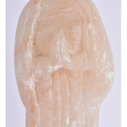 376 - AN EARLY EUROPEAN CARVED ALABASTER FIGURE OF A STANDING SAINT modelled with hands clasped upon a nat... 