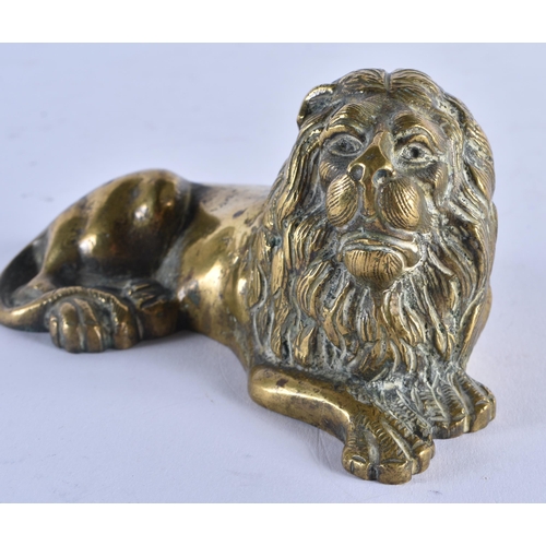 385 - AN EARLY 19TH CENTURY ENGLISH REGENCY BRONZE FIGURE OF A LION modelled recumbent. 12 cm x 6 cm.