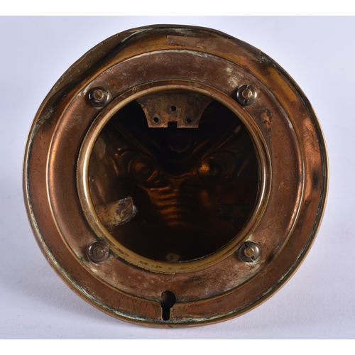 397 - AN ANTIQUE ARTICULATED BRASS GLASS EYED BULLDOG WALL MOUNT possibly formerly a bell. 12 cm wide.