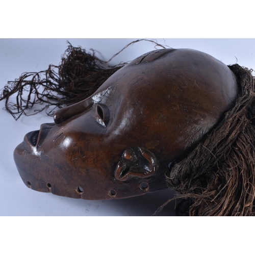 400 - TWO EARLY 20TH CENTURY AFRICAN LWENA TRIBAL WOOD MASKS together with a Chokwe mask. Largest 38 cm x ... 