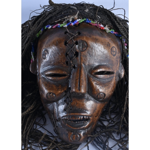 400 - TWO EARLY 20TH CENTURY AFRICAN LWENA TRIBAL WOOD MASKS together with a Chokwe mask. Largest 38 cm x ... 