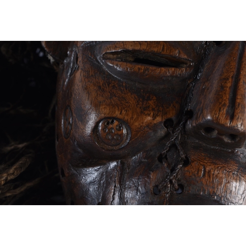 400 - TWO EARLY 20TH CENTURY AFRICAN LWENA TRIBAL WOOD MASKS together with a Chokwe mask. Largest 38 cm x ... 