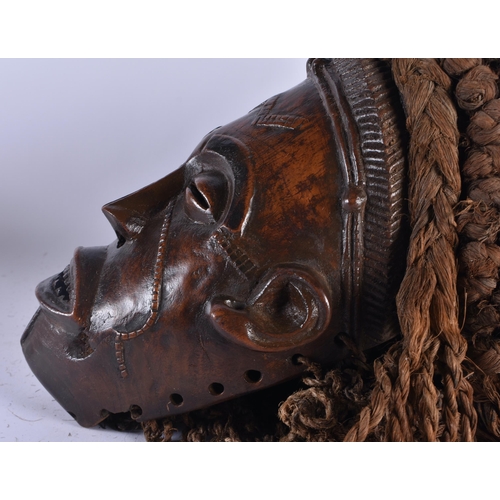 400 - TWO EARLY 20TH CENTURY AFRICAN LWENA TRIBAL WOOD MASKS together with a Chokwe mask. Largest 38 cm x ... 