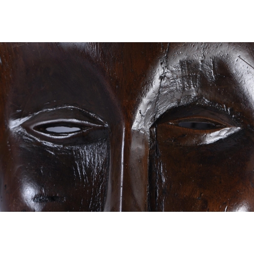 400 - TWO EARLY 20TH CENTURY AFRICAN LWENA TRIBAL WOOD MASKS together with a Chokwe mask. Largest 38 cm x ... 