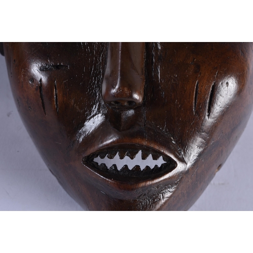 400 - TWO EARLY 20TH CENTURY AFRICAN LWENA TRIBAL WOOD MASKS together with a Chokwe mask. Largest 38 cm x ... 