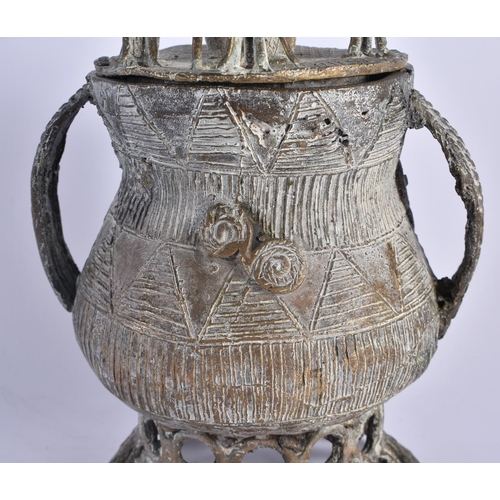 442 - AN AFRICAN TRIBAL BRONZE VESSEL AND COVER formed with figures upon an open work base. 24 cm x 13 cm.