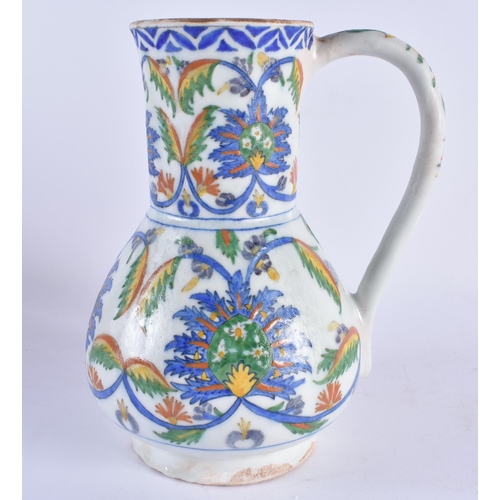 447 - A LARGE TURKISH KUTAHYA IZNIK STYLE POTTERY JUG. 23.5 cm high.