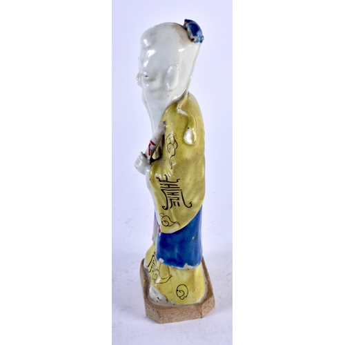 453 - A LATE 18TH/19TH CENTURY CHINESE PORCELAIN FIGURE OF A MALE IMMORTAL modelled in yellow robes. 19 cm... 