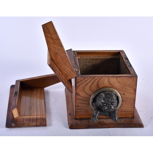 475 - AN EDWARDIAN PINE AND SPELTER NOVELTY TOBACCO BOX AND COVER formed with a dog leaving a kennel. 14 c... 