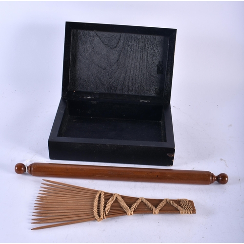 477 - AN UNUSUAL EARLY 20TH CENTURY COIN INSET EBONISED BOX together with a treen pencil case & a tribal f... 