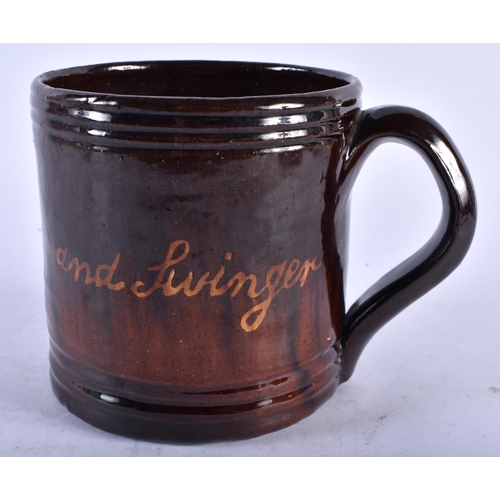 482 - A VERY UNUSUAL 19TH CENTURY ENGLISH TREACLE GLAZED SURPRISE MUG unusually formed with a recumbent do... 