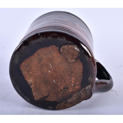 482 - A VERY UNUSUAL 19TH CENTURY ENGLISH TREACLE GLAZED SURPRISE MUG unusually formed with a recumbent do... 