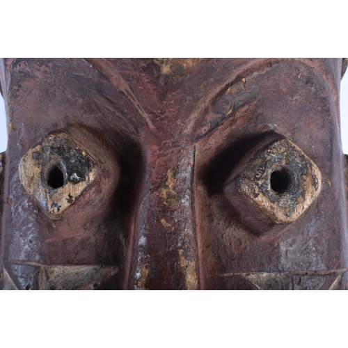 490 - A LARGE AFRICAN TRIBAL CARVED WOOD MASK. 48cm x 18cm.