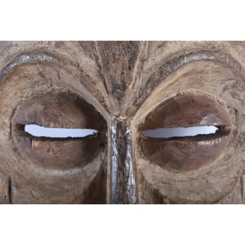 492 - A LARGE AFRICAN TRIBAL CARVED WOOD MASK. 45cm x 20 cm.