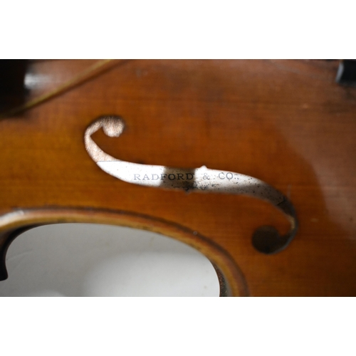 513 - A TWO PIECE BACK VIOLIN with three bows, by Radford & Co of Derby. Violin 57.5 cm long, length of ba... 