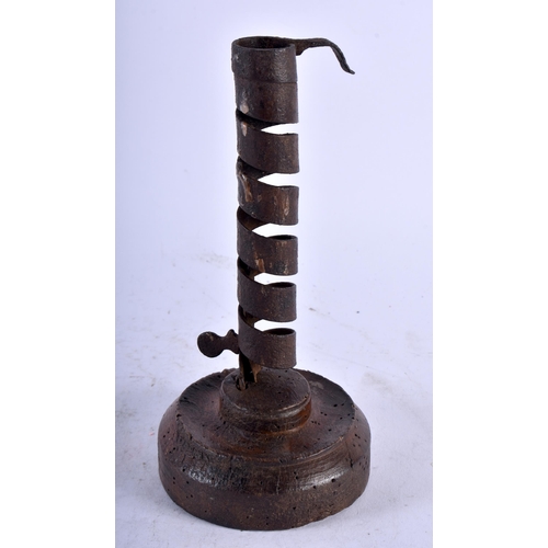 535 - AN EARLY IRON PIGTAIL TWIST CANDLESTICK. 20 cm high.