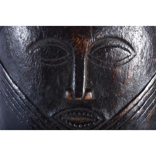 557 - AN AFRICAN TRIBAL CONGOLESE CARRYING MASK WOOD VESSEL. 22cm x 14 cm.