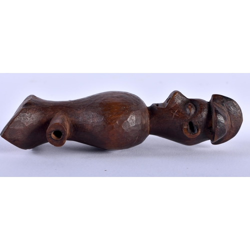 580 - AN AFRICAN TRIBAL CARVED WOOD WHISTLE. 12 cm x 4 cm.