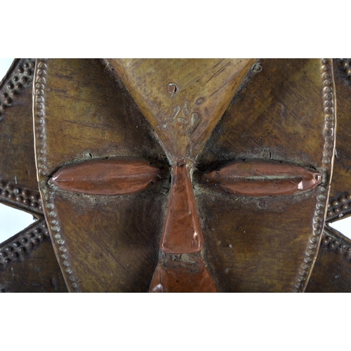 582 - A LARGE TRIBAL BRASS AND COPPER MOUNTED AFRICAN FIGURE. 50cm x 24 cm.