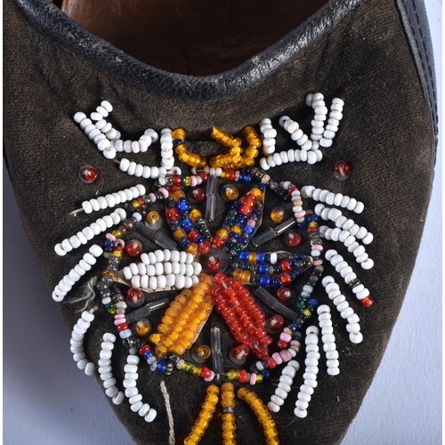 583 - A PAIR OF ANTIQUE BEADWORK SHOES. 24.5 cm long.